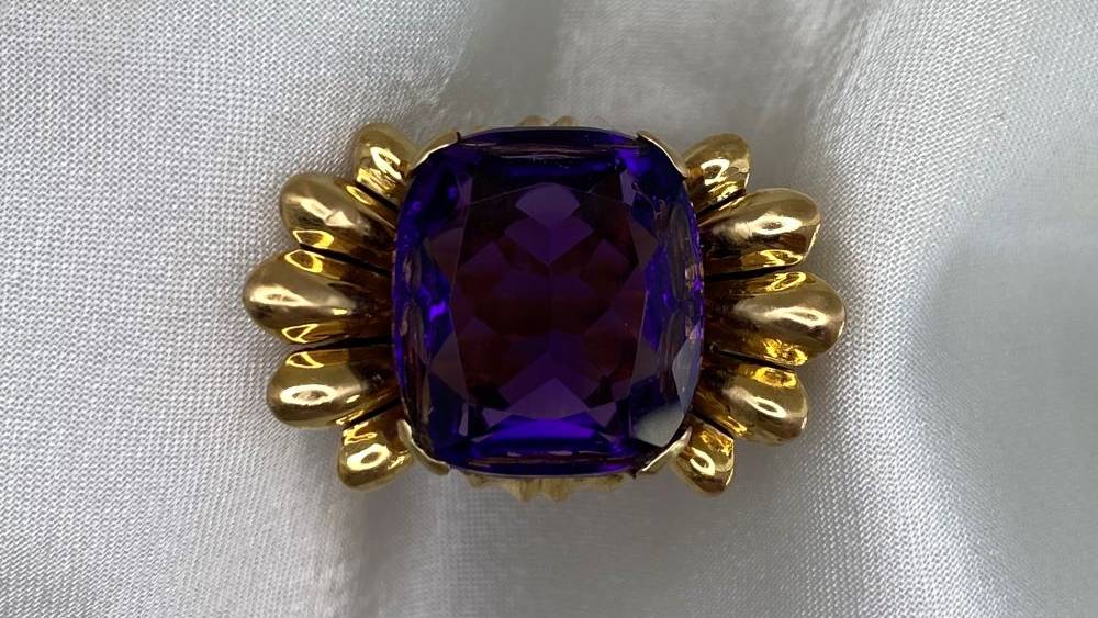 An amethyst ring with an 18k rose gold petal motif mounting.