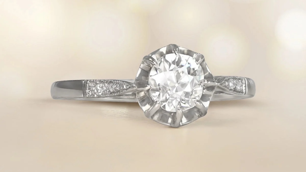 A dainty 14k white gold ring with a diamond in box prongs