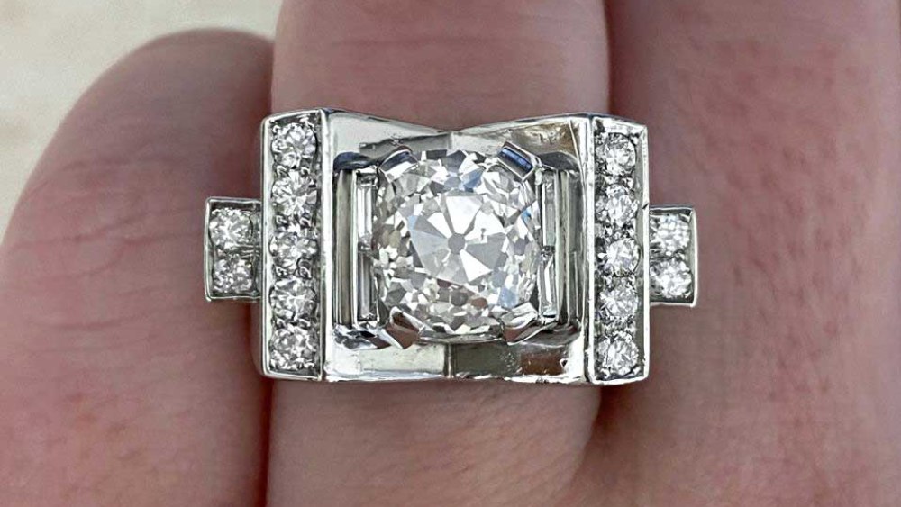 A chunky retro diamond ring featuring additional diamonds.