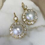 pear of cluster earrings featuring two Saltwater natural round button pearls