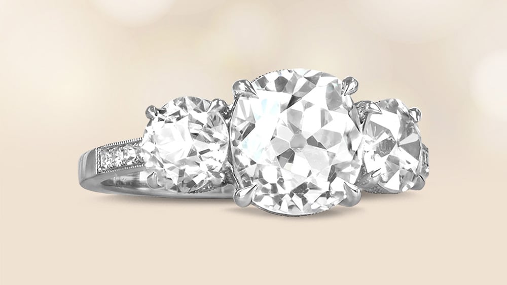 three stone diamond ring set in a pavé platinum band
