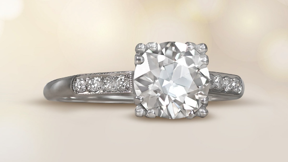A solitaire diamond ring with four triple prongs.
