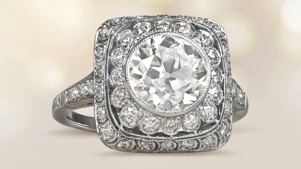 A square diamond ring with elaborate openwork ornamentation.
