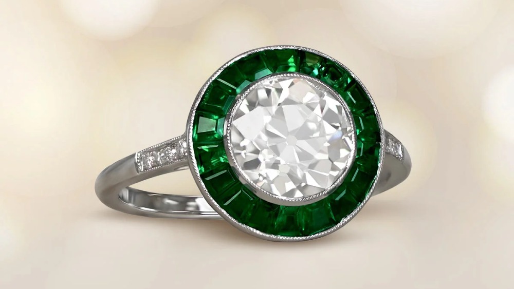 A round diamond ring with a green emerald halo.