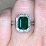 halo engagement ring featuring an emerald cut diamond