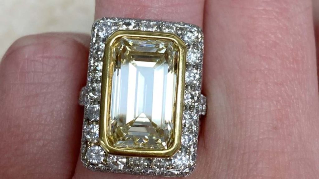 7.07 carats fancy light yellow emerald cut diamond with white diamond halo