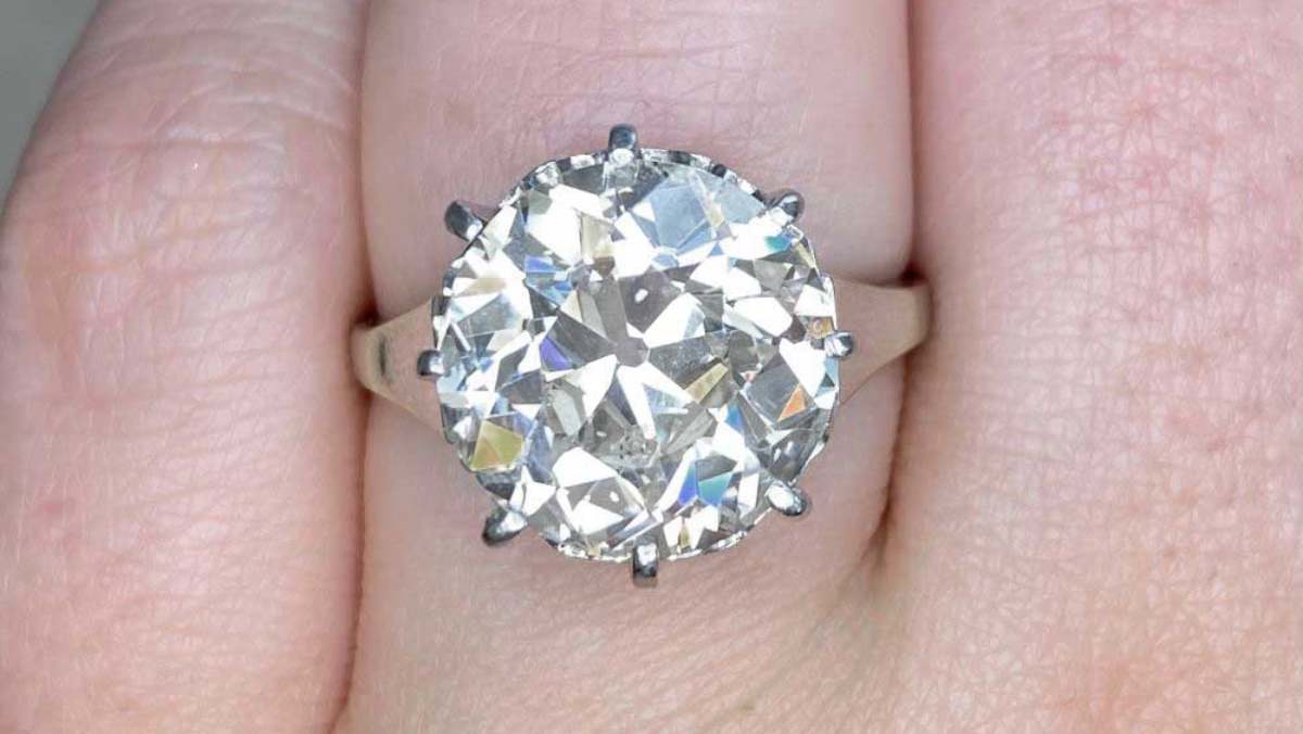 art deco ring centering a 6.79 carat diamond set in prongs