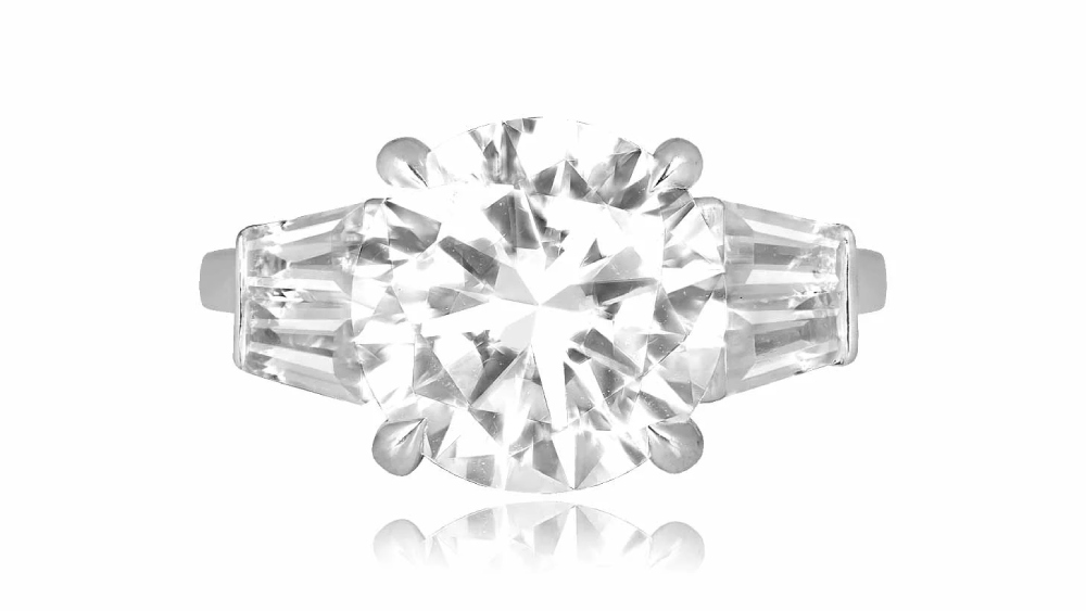 A diamond ring with tapered baguette diamonds on the shoulders.
