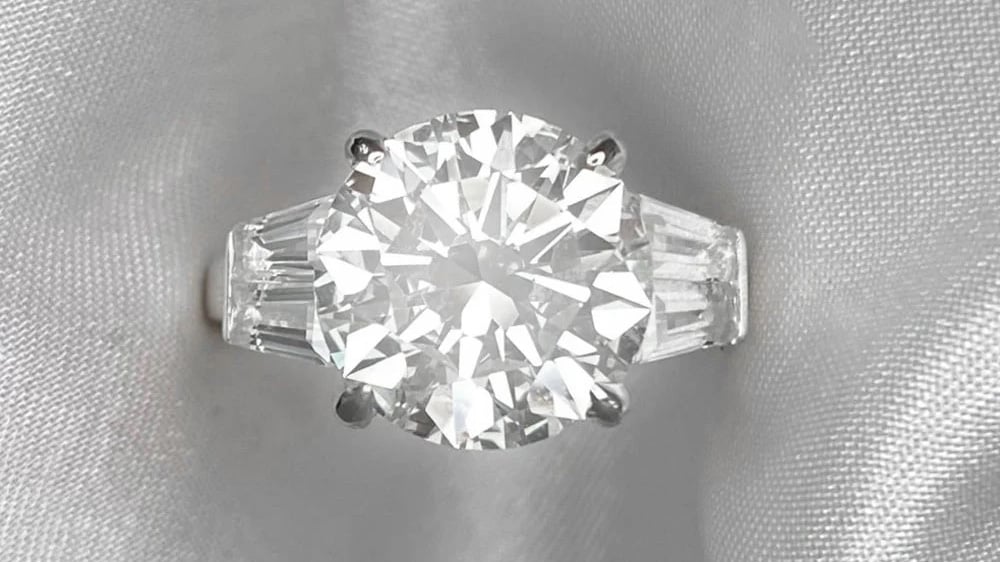 A diamond ring with side-by-side tapered baguette diamond shoulders.