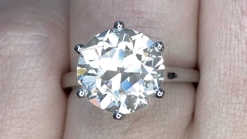 A solitaire ring featuring a round diamond in six prongs.