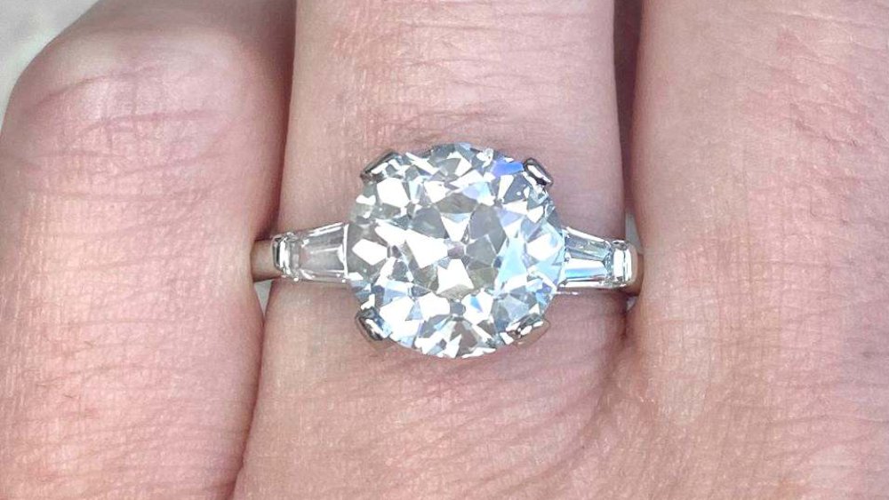 A delicate diamond ring with tapered baguette diamond shoulders.