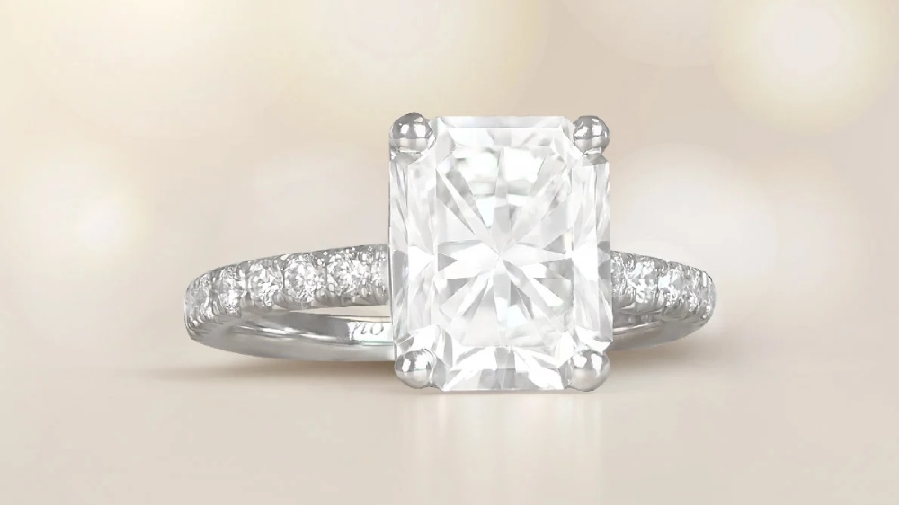 A large radiant-cut diamond on a micro-pave diamond band.