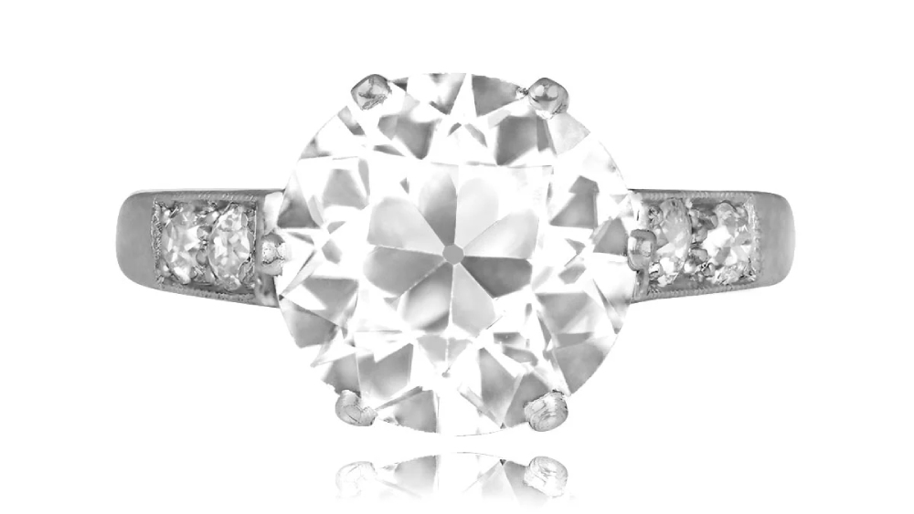 A white gold solitaire diamond ring with shoulder diamonds.
