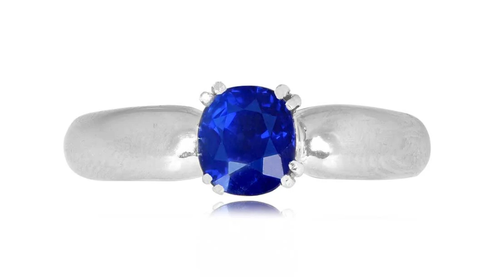 A delicate white gold ring with a sapphire in double prongs.