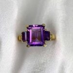 zima ring with prong-set trapezoid-cut amethysts