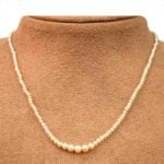 String of Natural Saltwater Pearl Necklace Birnam Necklace with Busk Background MD211