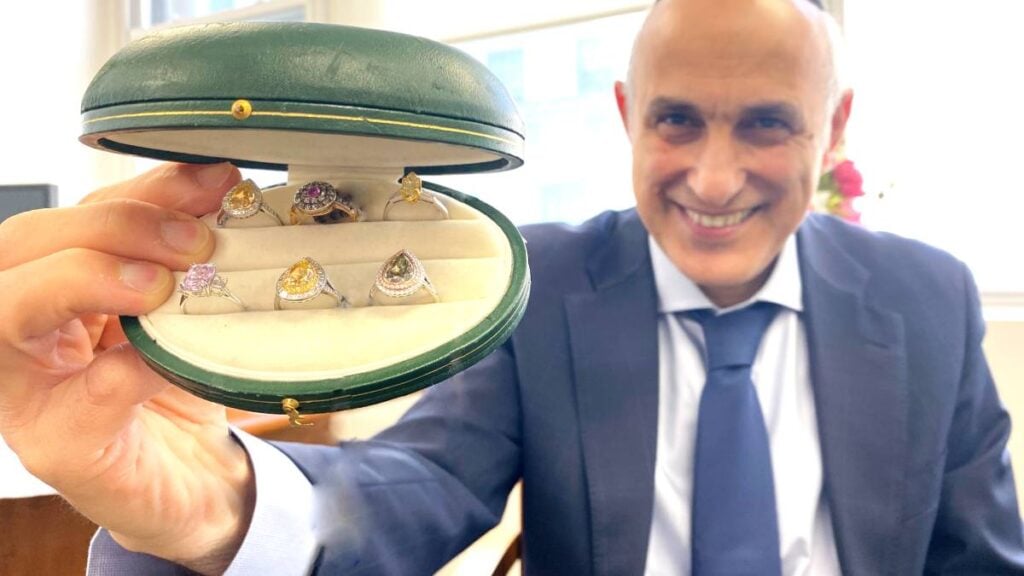 Afshin with colored diamond rings in ring box Jewelry