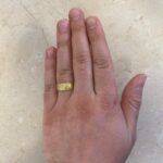 intricate detailing 18k yellow gold mens band with a graduating width