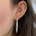 earrings featuring prong set diamonds in an inside-out hoop design