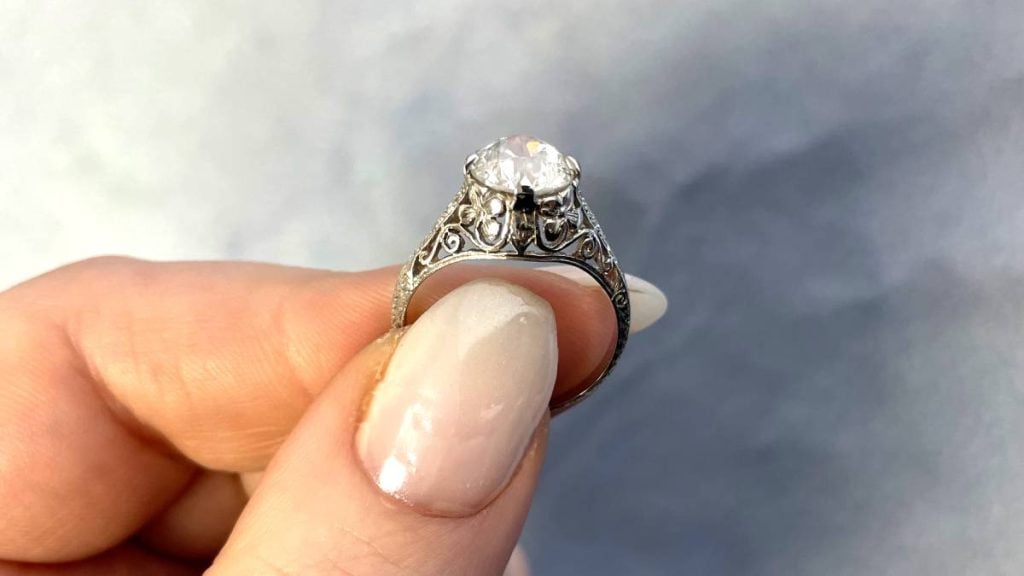 Floral Filigree on Engagement Ring holding Finger