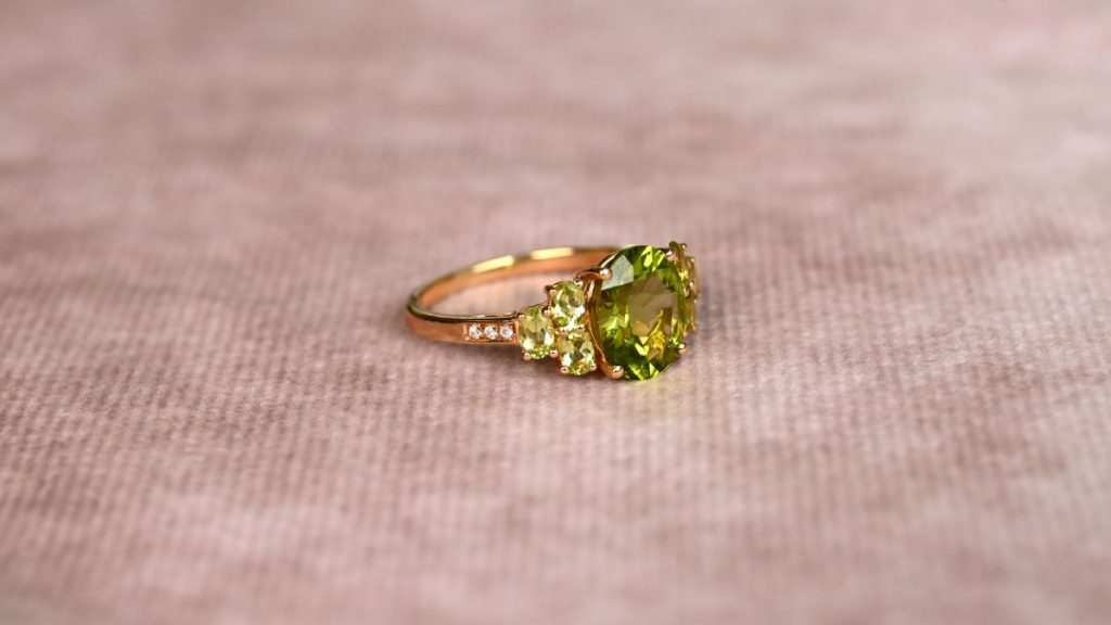 Close up of August Birthstone Ring with peridot and diamond accents