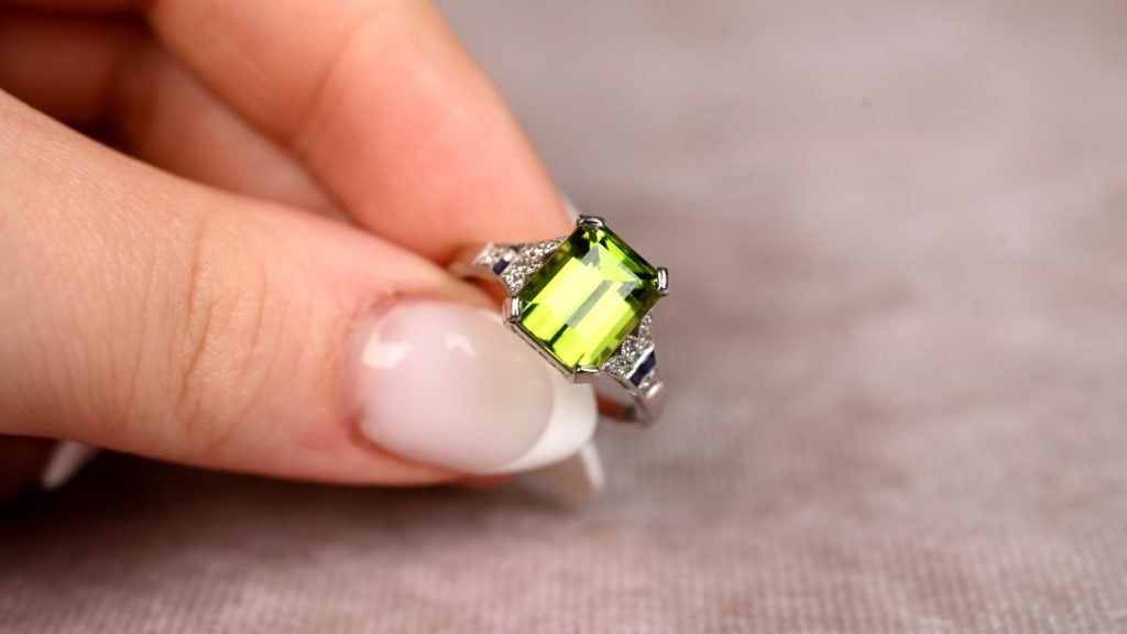 Model Holding Rare Peridot August Birthstone Ring