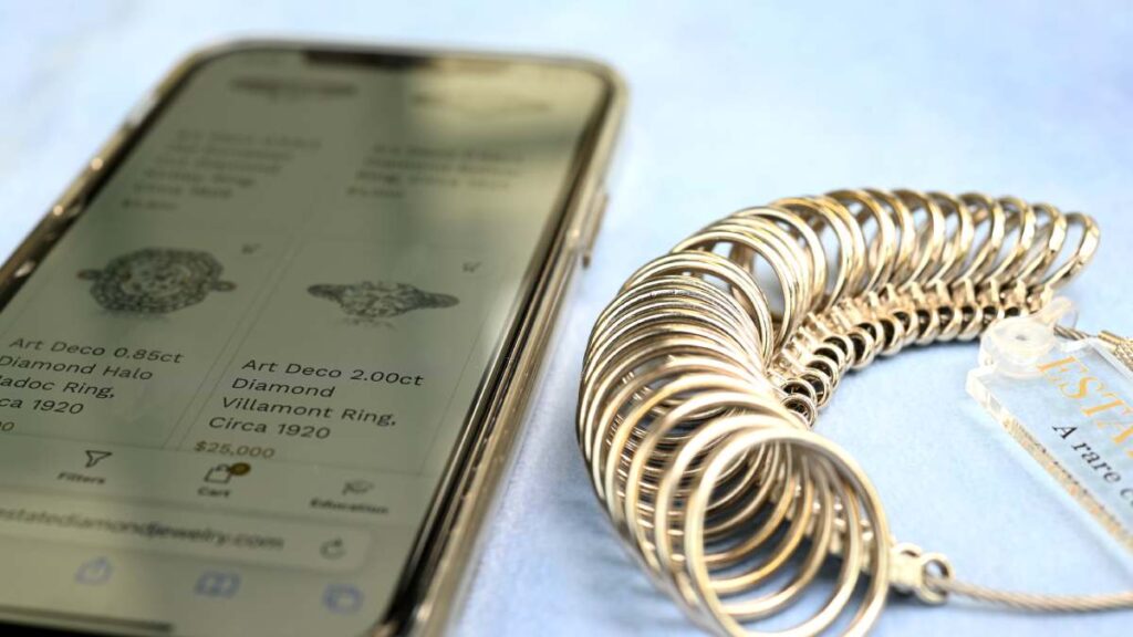 Smartphone shopping online on Estate Diamond Jewelry website and ring sizer
