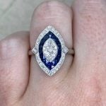 Surama Ring centering a 0.71 carat antique marquise cut diamond