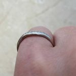 Notch Band featuring a row of round brilliant cut diamonds
