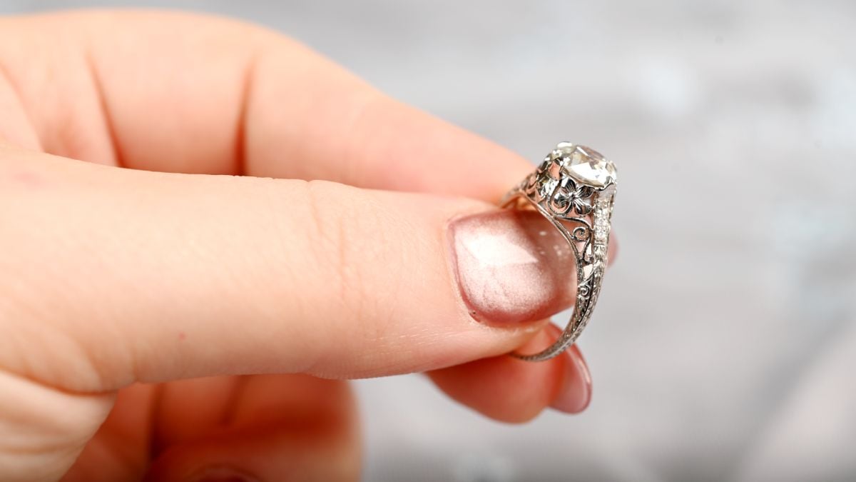 Holding Antique Heirloom Diamond Engagement Ring