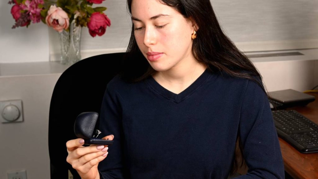 Girl examining an EDJ diamond ring in box