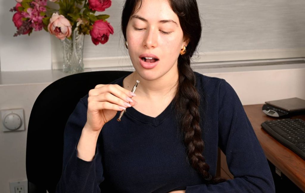 Jeweler breathing hot on a diamond to test it