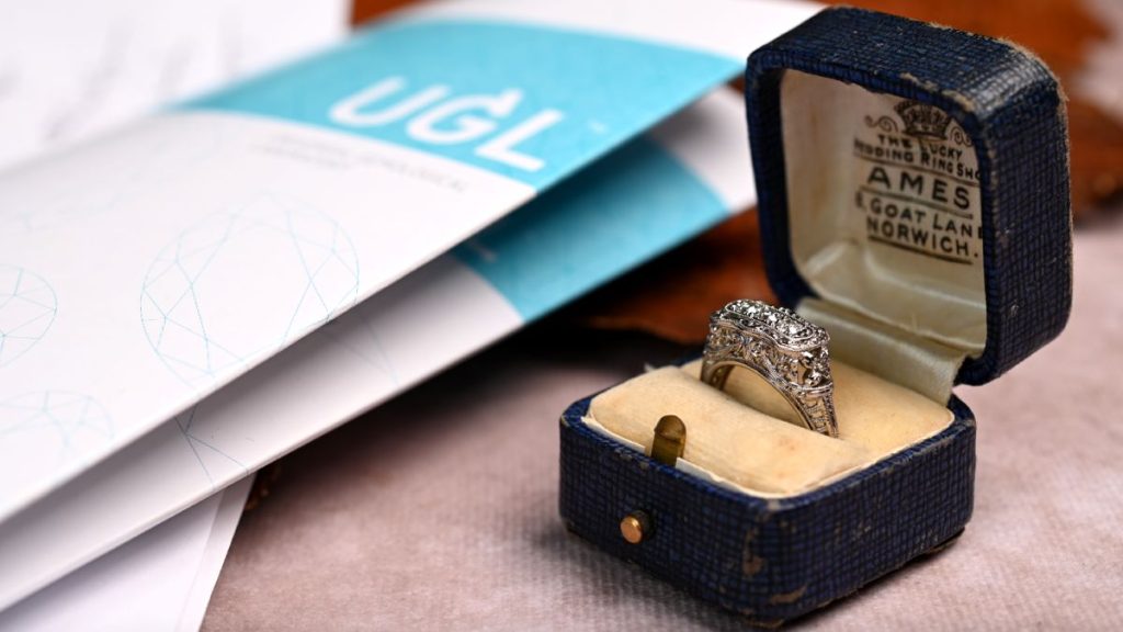 Antique ring in box next to UGL documents