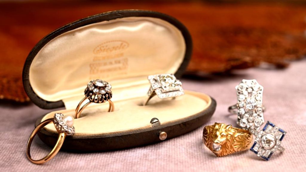 Group of antique rings on table and box