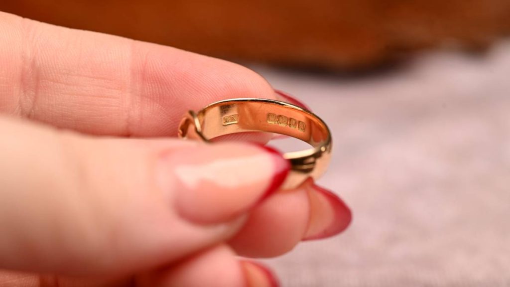 Model holding ring with hallmarks and makers mark