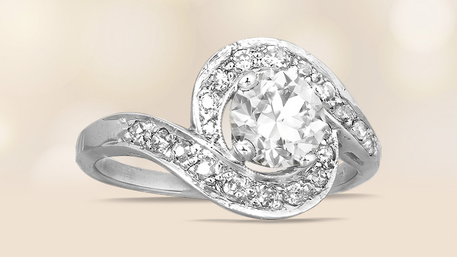 Retro era swirl design ring with a center old European cut diamond and pave set single curt diamonds