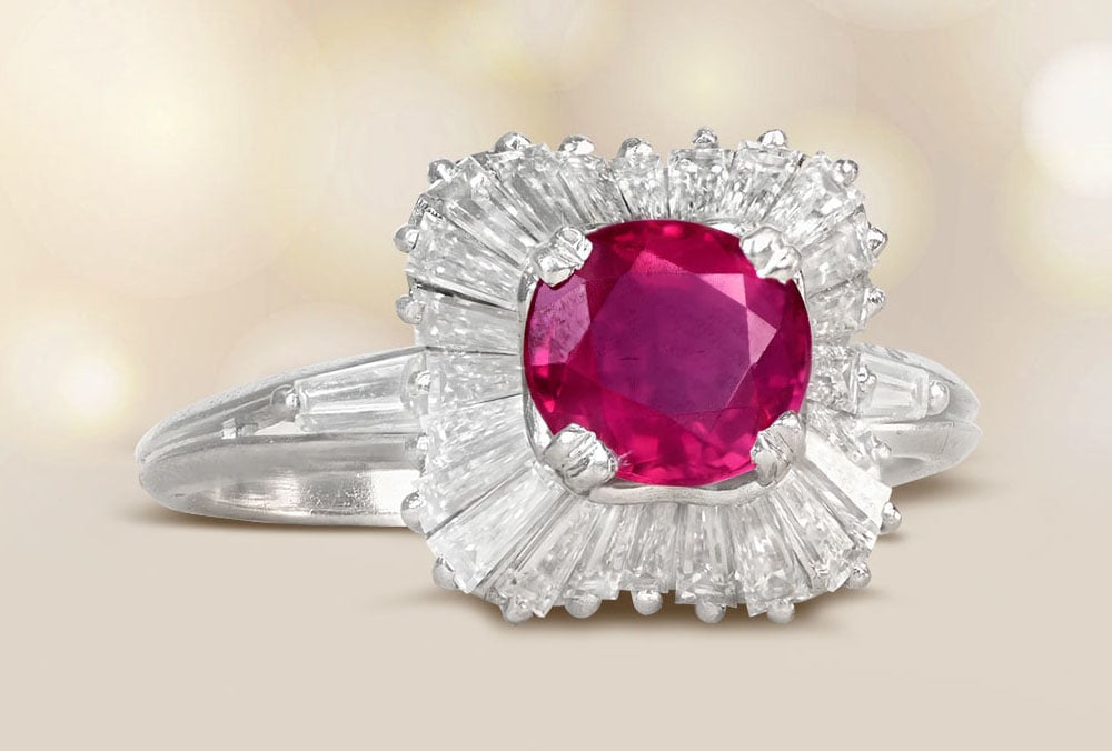 A ruby ring with an ornate halo of baguette diamonds.