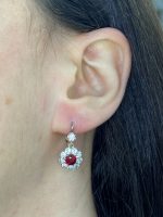 floral earrings centering two prong-set round ruby stones