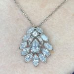 VCA pendant centering a pear shaped diamond surrounded by marquise