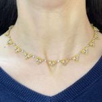 Buccellati necklace with diamond detailing and surrounded by a textured yellow gold rim
