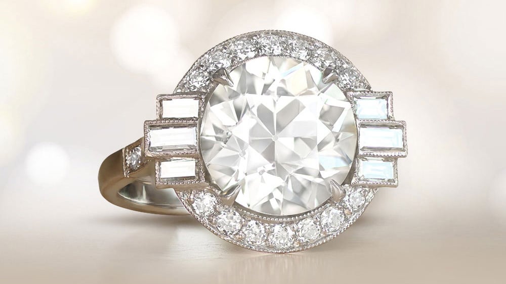 diamond platinum ring with a halo of smaller diamonds and baguette cut side diamonds