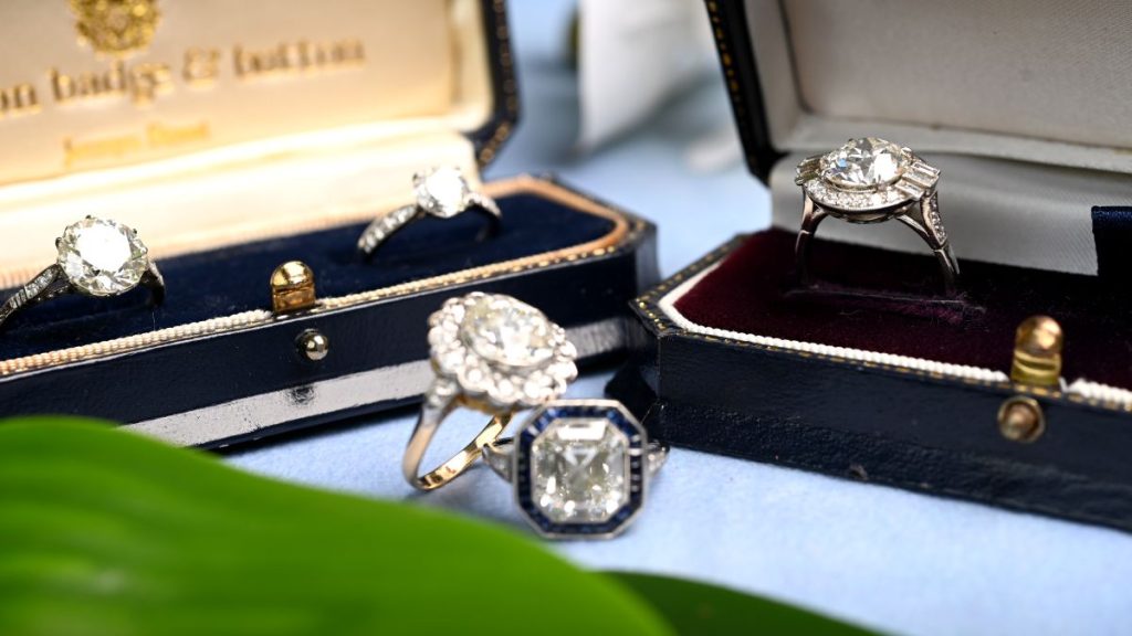 Collection of Engagement Rings in Boxes and Nearby
