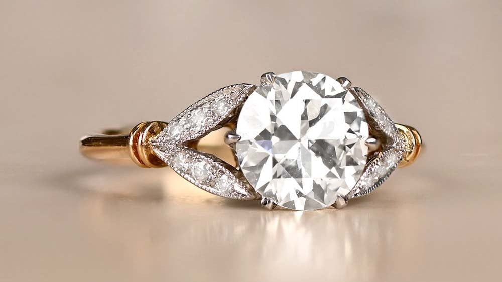 old European cut diamond ring with leaf motif side diamonds set in platinum and gold