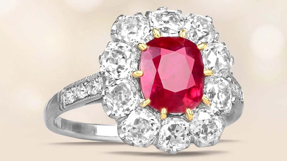 cushion cut natural not heated Burma ruby ring with a halo of diamonds set in platinum and gold