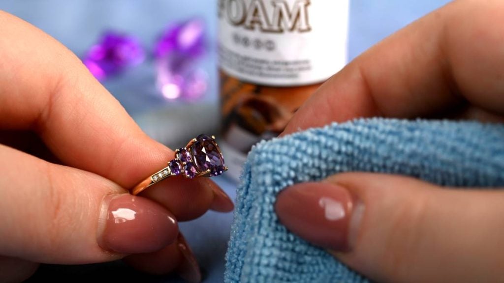 Cleaning beautiful February amethyst birthstone ring with cloth cleaner