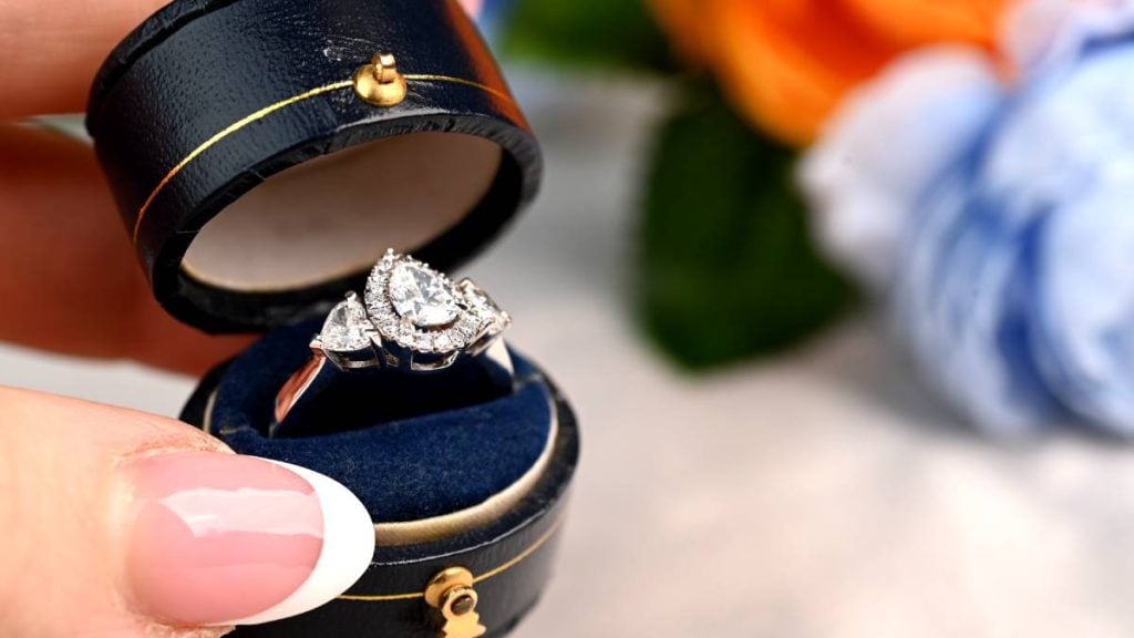 Customer Holding Pear Cut Diamond Three Stone Ring