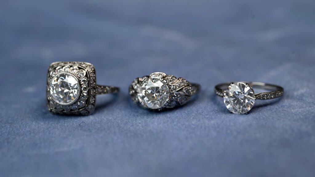Different Style engagement rings on blue tile