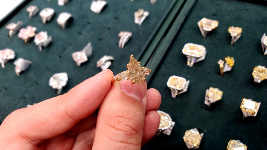 Expert holding Fancy Brown Diamond Ring in Showroom