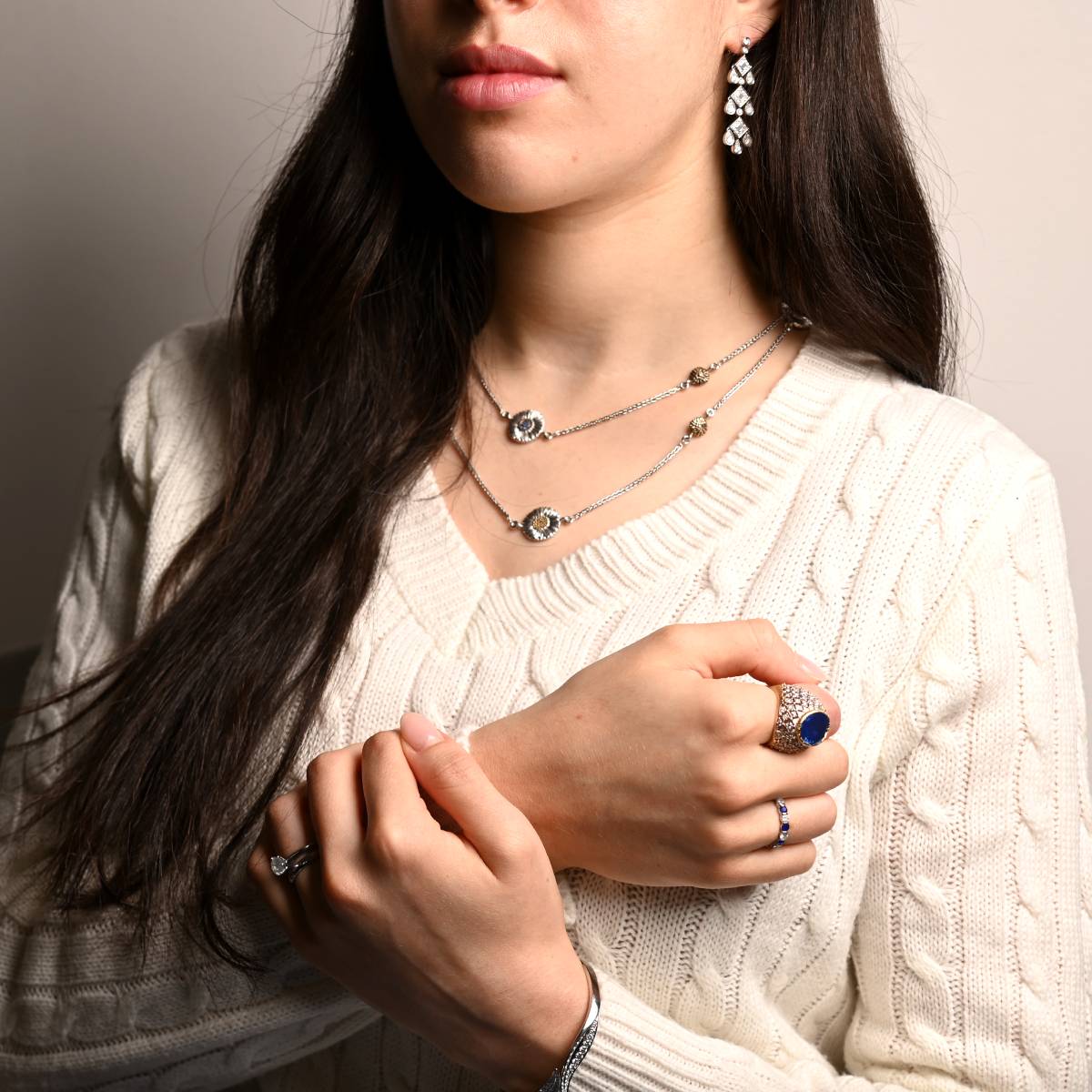Model wearing luxury designer jewelry tiffany cartier and buccellati