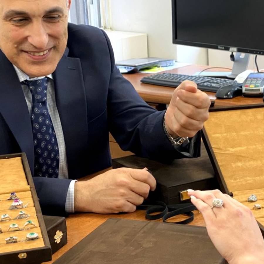 Afshin helping a customer view vintage jewelry